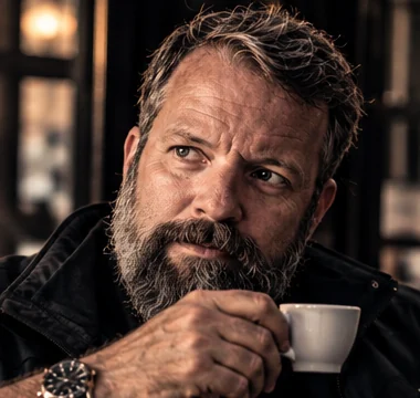 Close portrait of Simon Locke holding an espresso cup